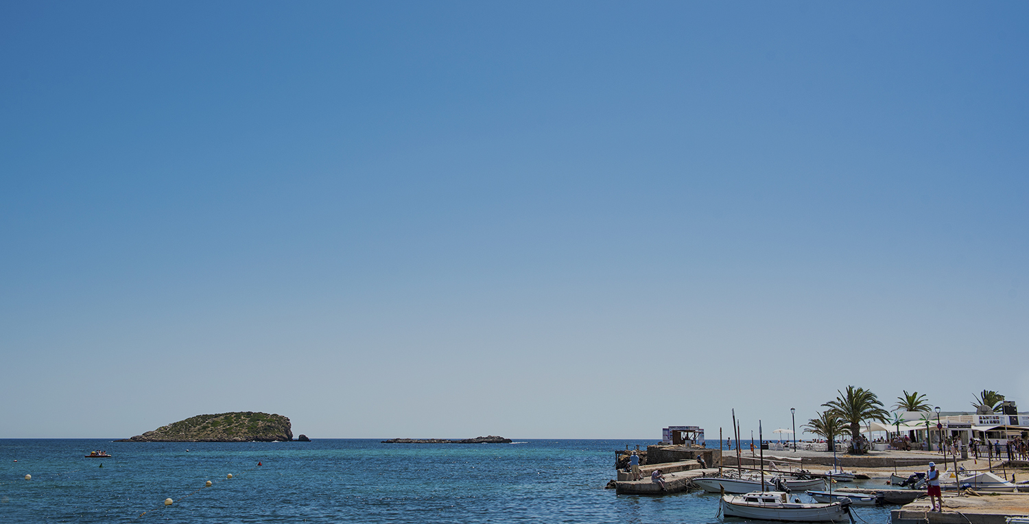 The turquoise bay and seafront at Es Canar