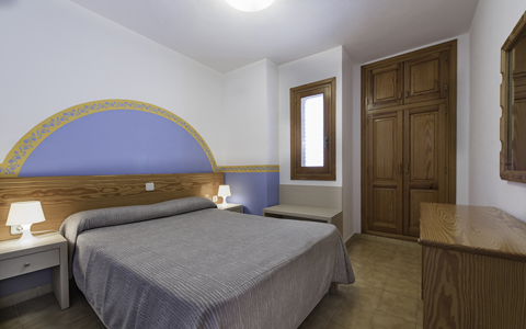 Comfortable double bedroom with traditional Ibizan woodwork